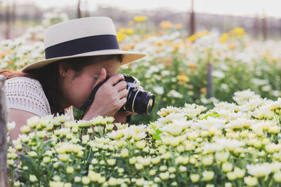 Portrait of man photographing with camera