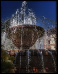 Close-up of water splashing in fountain against sky