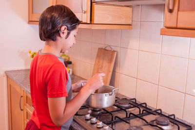 Young man preparing food at home