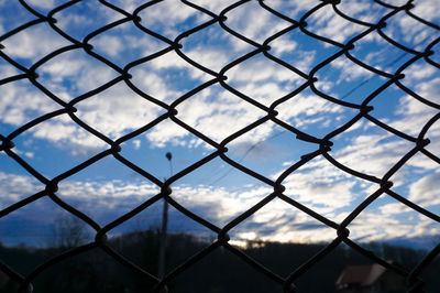 Full frame shot of chainlink fence against sky