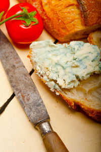 Fresh blue cheese spread ove french baguette with cherry tomatoes on side