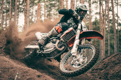 Man riding motorcycle in forest