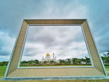 Low angle view of building against cloudy sky