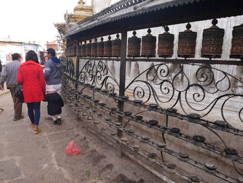 Rear view of people walking on building