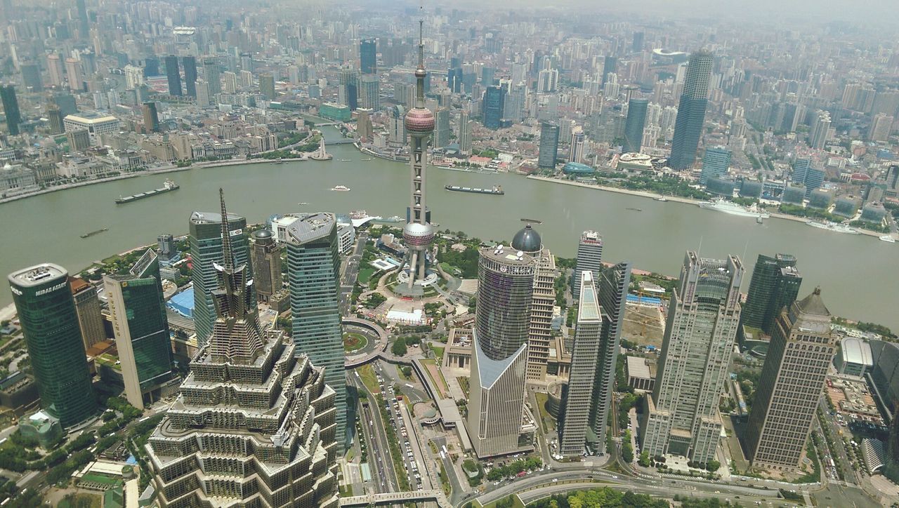 cityscape, city, building exterior, architecture, built structure, skyscraper, crowded, high angle view, aerial view, tower, capital cities, tall - high, modern, travel destinations, office building, financial district, water, residential district, famous place, city life