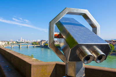 Telescope over rhine river and city of basel in a sunny day in switzerland.