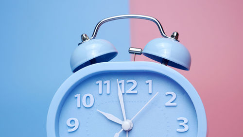 Close-up of clock against blue background