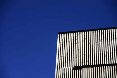 Low angle view of building against clear blue sky