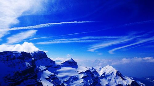 Scenic view of mountains against cloudy sky