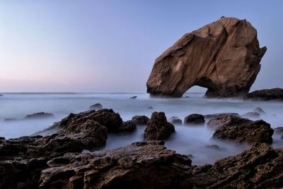 Scenic view of rocks on seashore