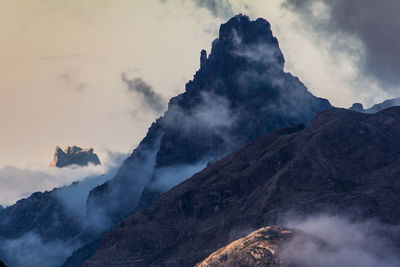 Scenic view of mountains against cloudy sky