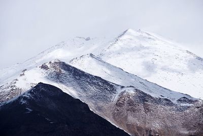 Close-up of glacier on mountain against sky