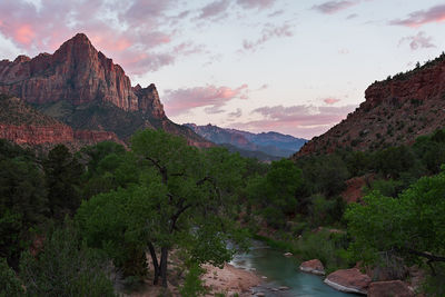 Scenic view of river amidst mountains against sky