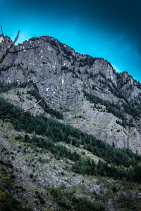 Scenic view of mountains against blue sky