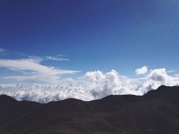 Scenic view of mountains against cloudy sky