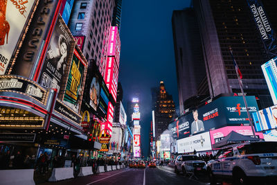 Low angle view of illuminated buildings in city