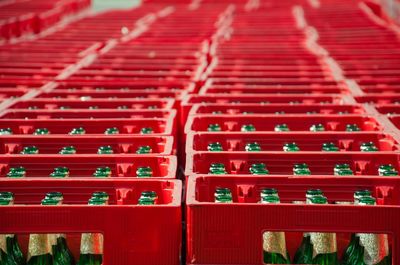 High angle view of beer bottles in crates for sale