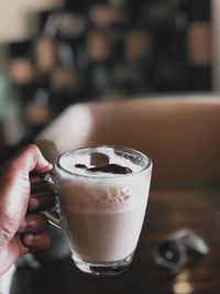 Close-up of hand holding coffee cup