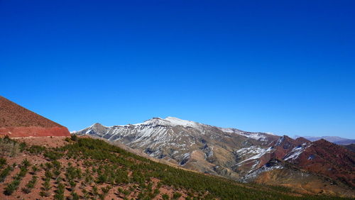 View of mountain range against blue sky