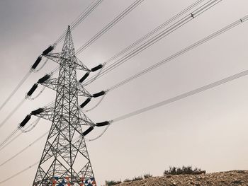 Low angle view of electricity pylon against sky