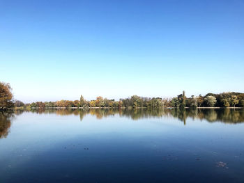 Scenic view of lake against clear blue sky