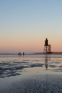 Scenic view of sea against clear sky during sunset