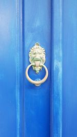 Close-up of blue door knocker