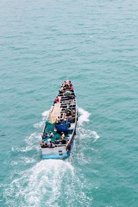 High angle view of people on boat in sea