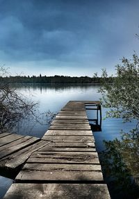 Pier over lake against sky