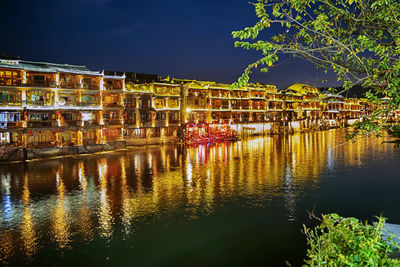 Reflection of illuminated buildings in water at night