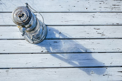 High angle view of lantern on wooden table