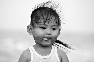 Portrait of cute girl against sky