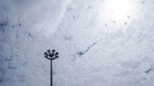 Low angle view of floodlight on snow against sky