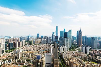 Aerial view of modern buildings in city against sky