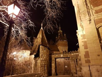 Low angle view of illuminated lighting equipment at night