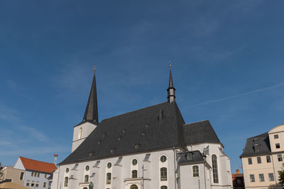 Low angle view of buildings against blue sky