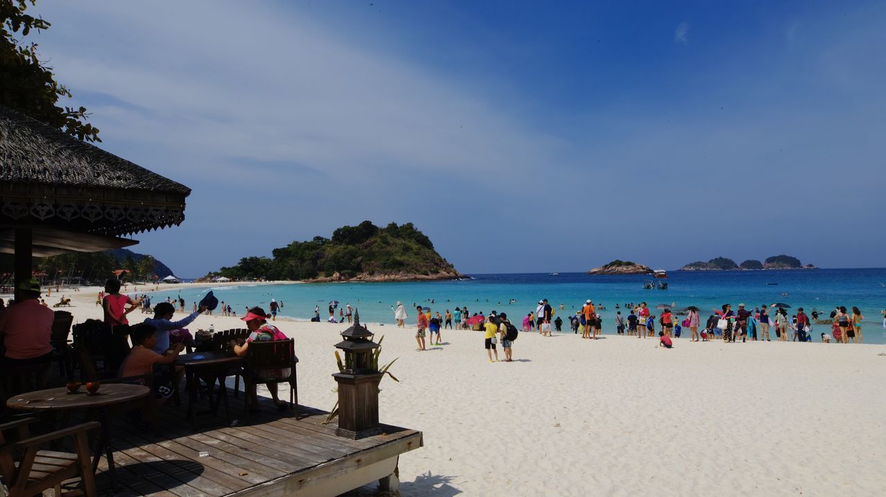 sky, group of people, sea, water, beach, land, real people, holiday, large group of people, men, nature, crowd, trip, vacations, leisure activity, architecture, lifestyles, relaxation, women, outdoors