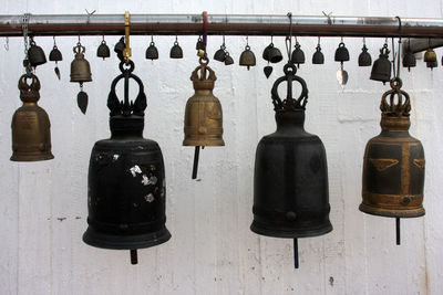 Bells against wall at temple