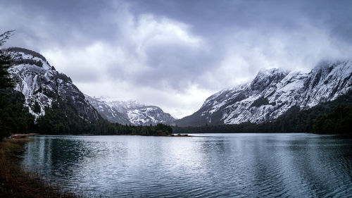 Scenic view of lake and snowcapped mountains against sky