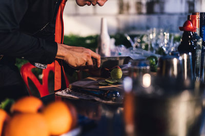 Young bartender working in party at night