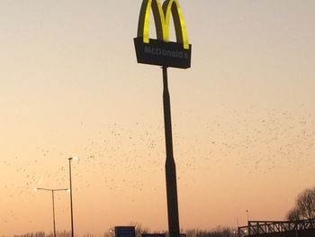 Low angle view of information sign against sky