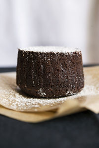 Close-up of chocolate cake on parchment paper