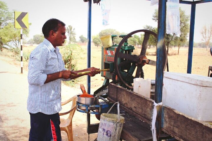 HIGH ANGLE VIEW OF MAN WORKING IN CART