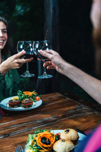 Couple toasting wineglasses at table in restaurant