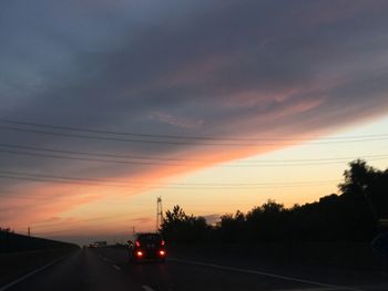 Cars on road at sunset