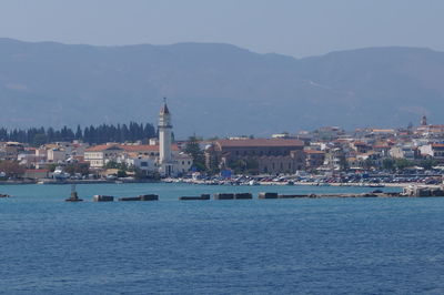 View of city at waterfront against sky