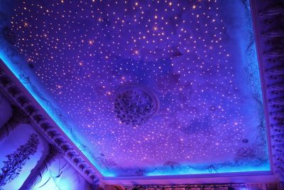 Low angle view of illuminated lighting equipment in water