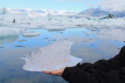 Cropped hand holding ice at jokulsarlon lake