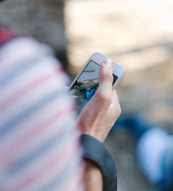 Cropped image of person holding mobile phone