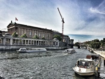 Boats in river with buildings in background